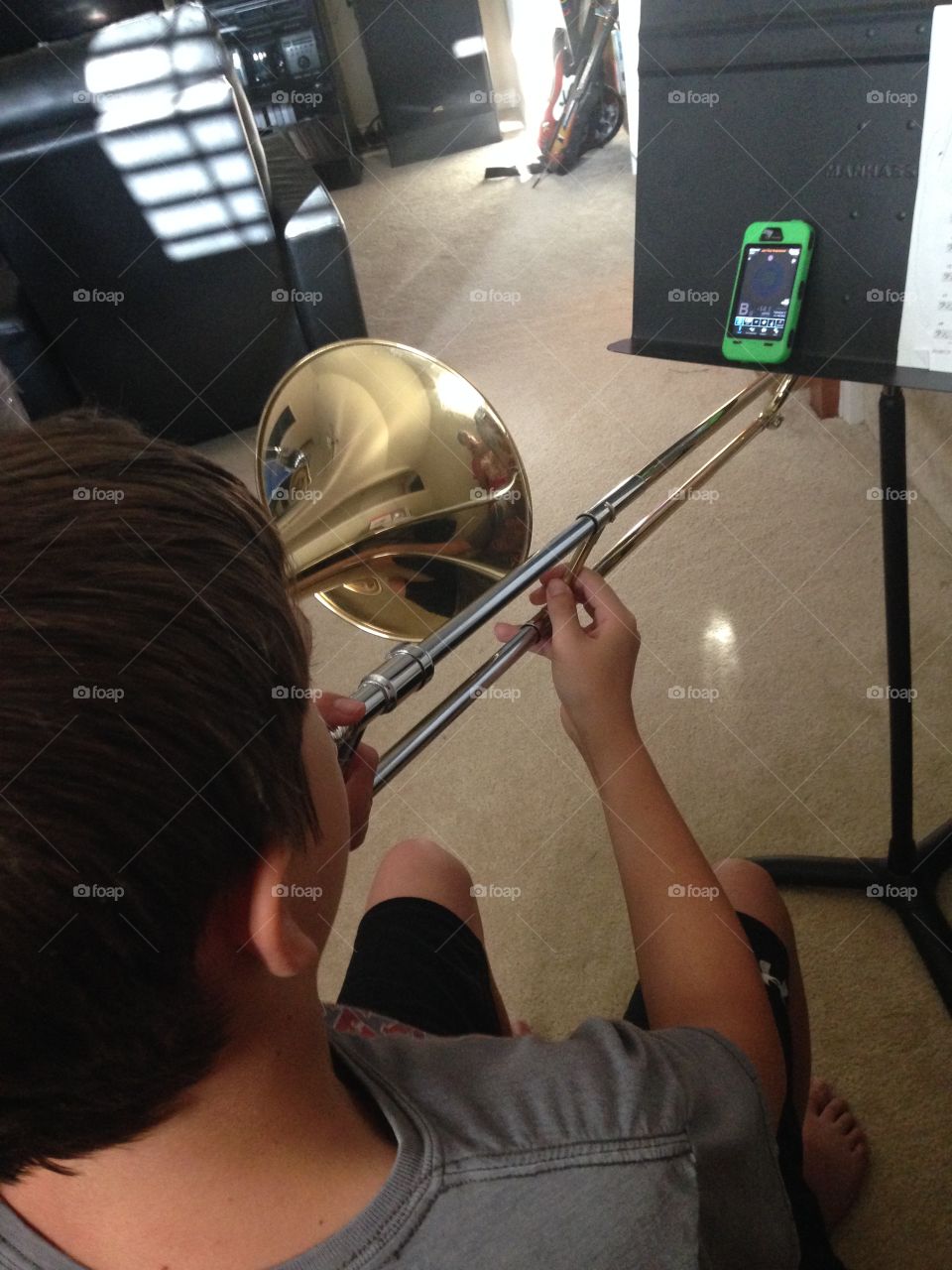 Practice makes perfect. Boy practicing trombone 