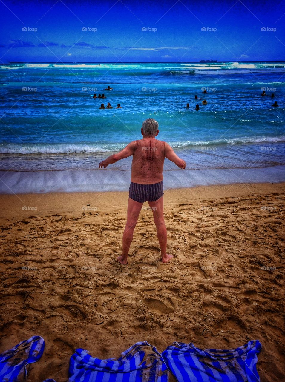 Old man exercising on Waikiki beach