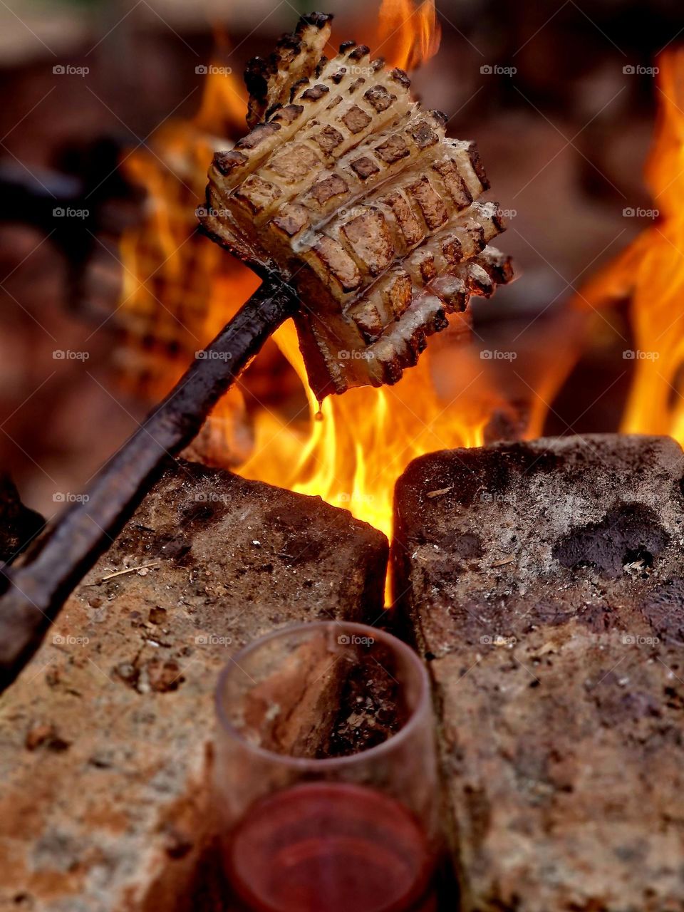 pork skewers on a campfire