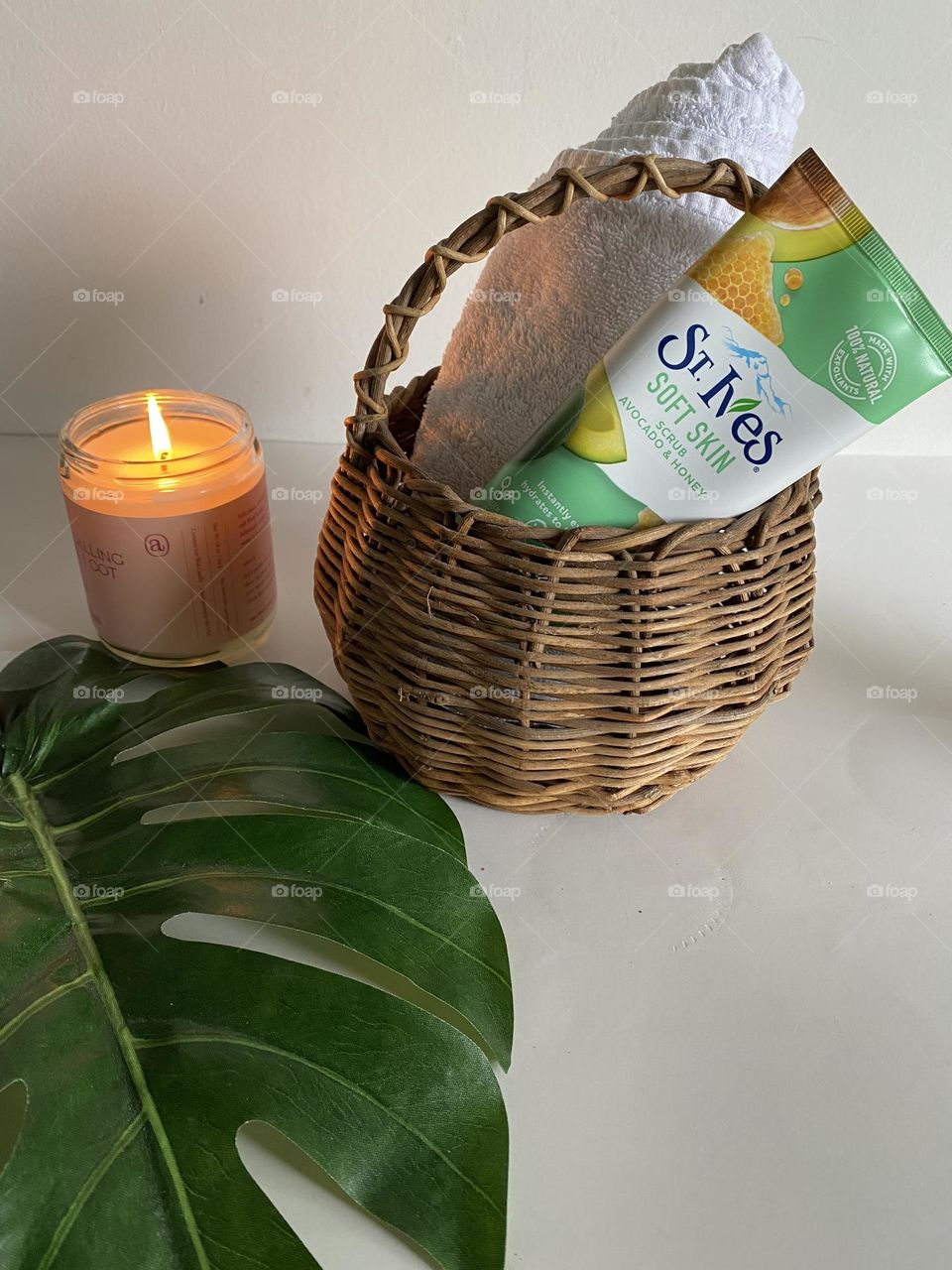 St Ives facial scrub and candle on white background 