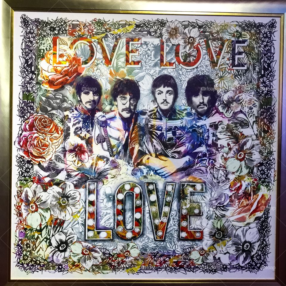Beatles Love poster with splashes of colour and light.