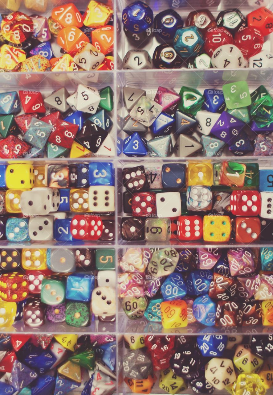 A box of multicolored gaming dice