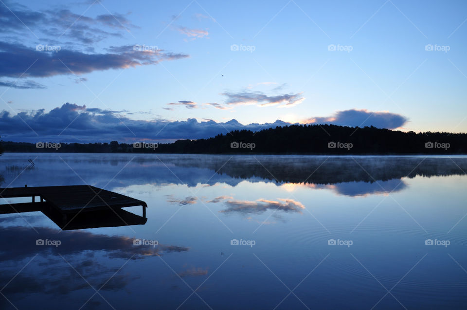 Silhouette of pier at lake