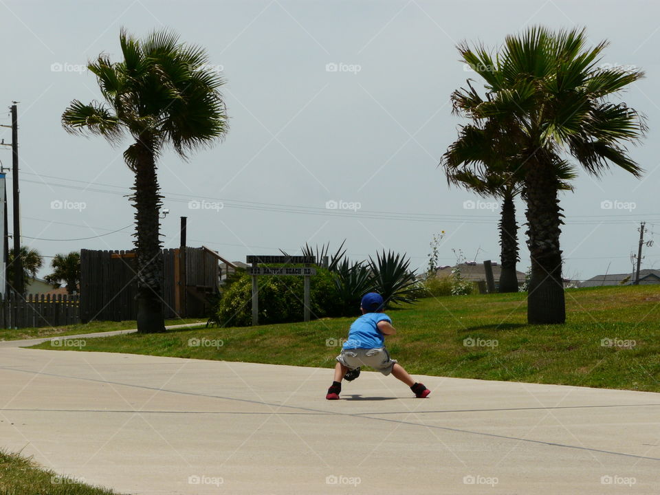 Playing catch even on vacation in front of the condo.. Playing catch even on vacation in front of the condo.