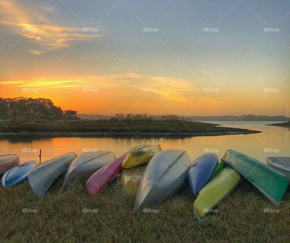 Fall sunsets are spectacular and colorful. Here’s an evening sunset over the bay with lots of colorful kayaks. 