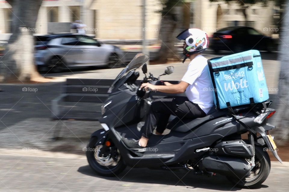 Wolt delivery man driving his scooter 