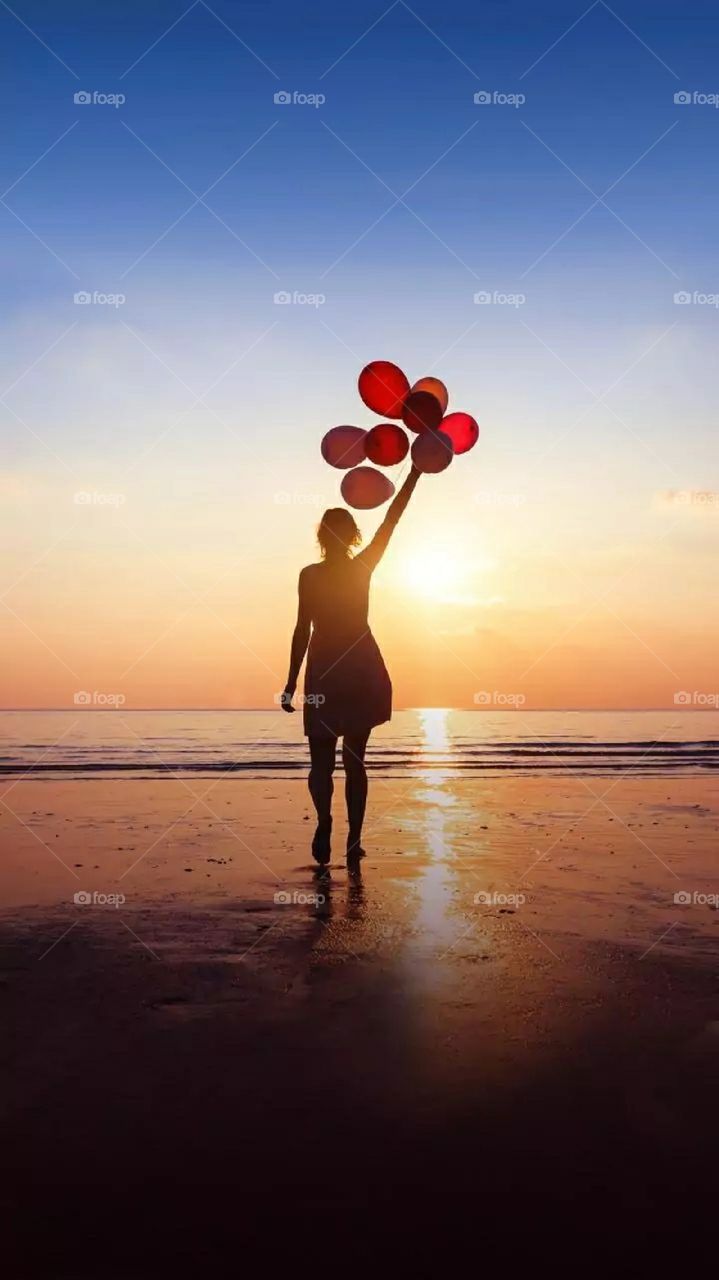 A girl at the beach in the evening.