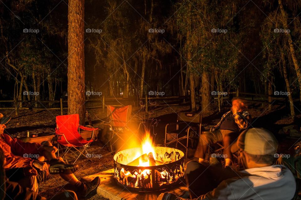 Adults at a campfire