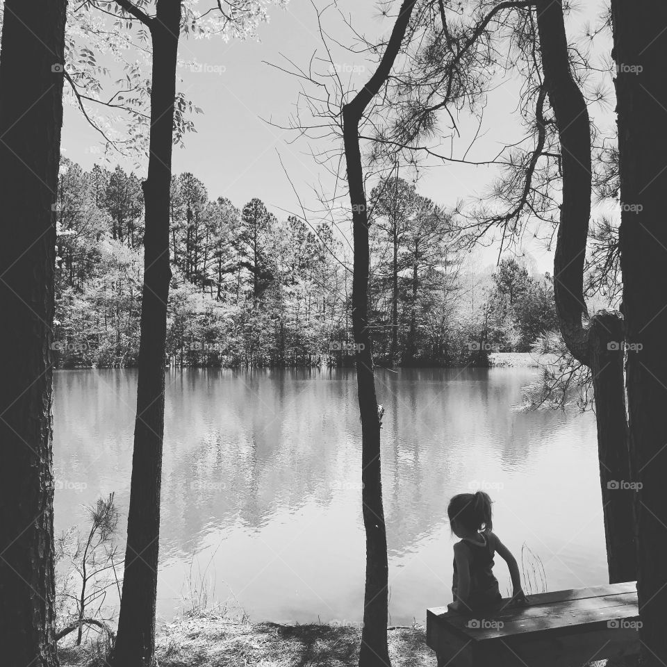 Little girl taking in the view and scenery during a hike. Hiking. Water. View. Lake. Trees. Break time. 