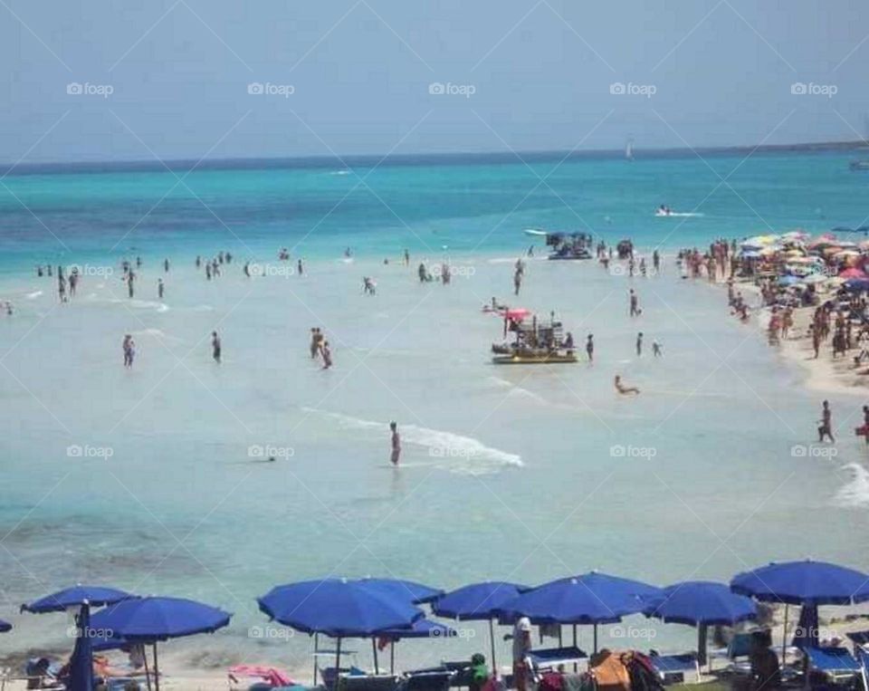 Beach#parasols#humans#sky