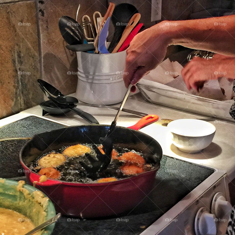 Women cooking tikka in kitchen