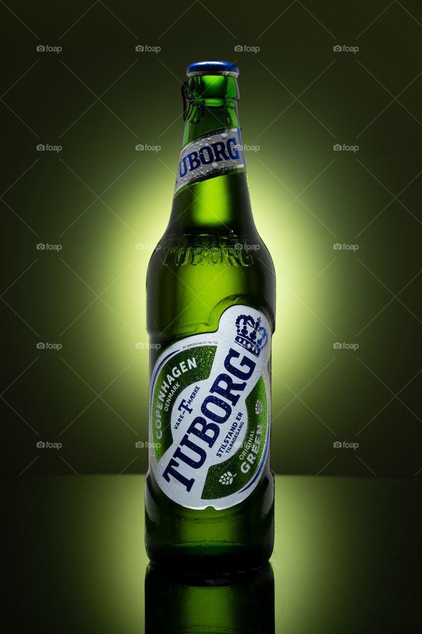 Tuborg beer on green background. Product photo