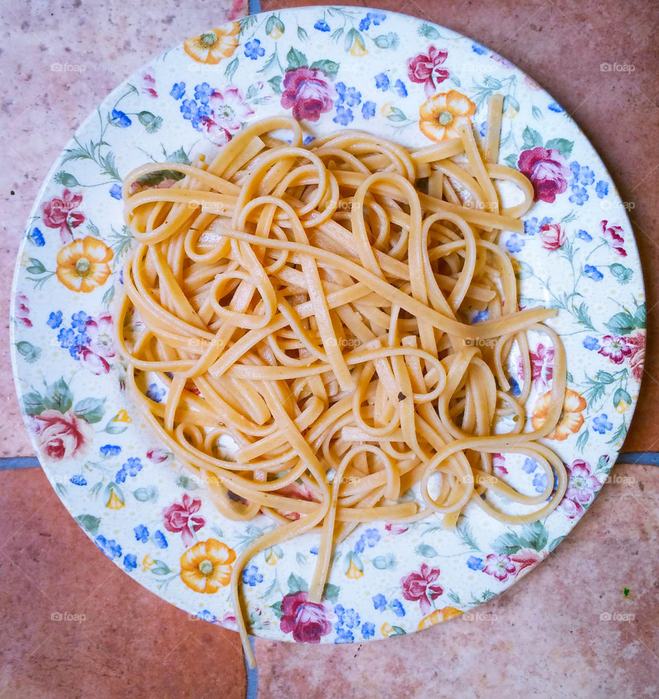 Wholemeal pasta on floral plate