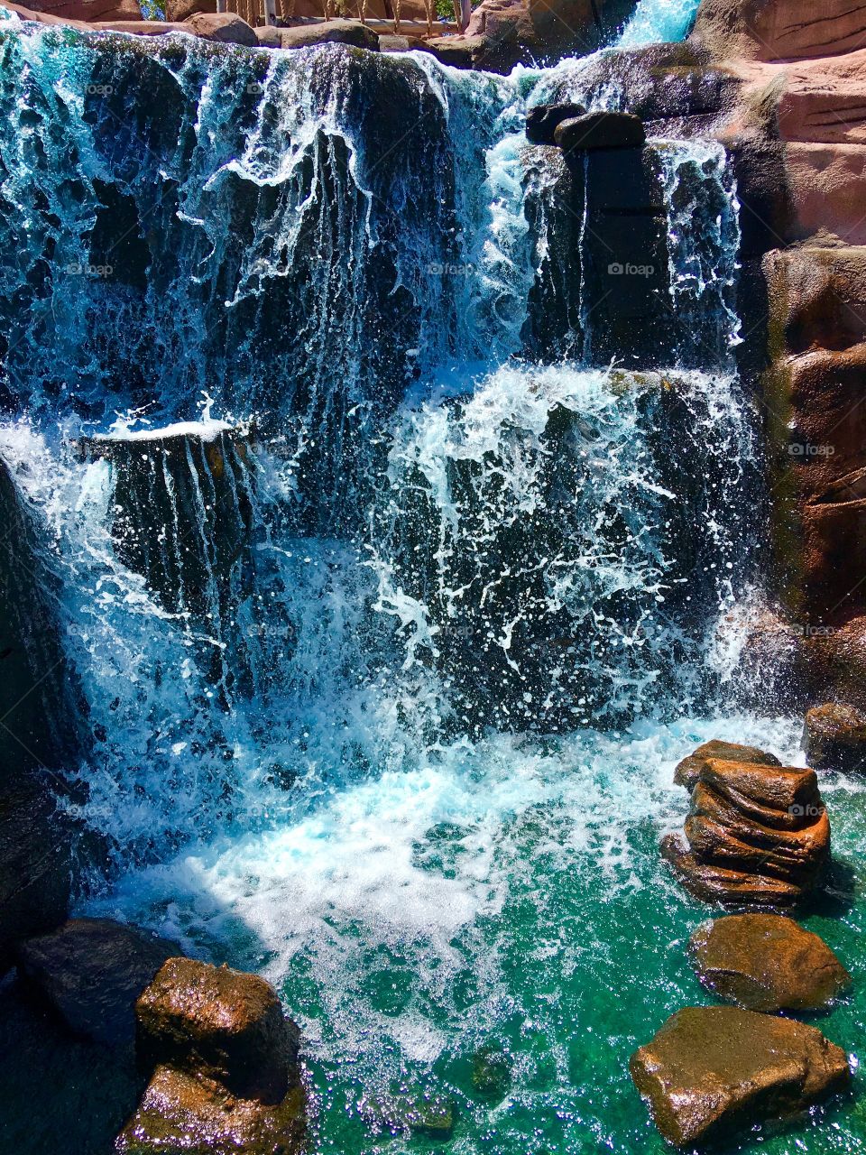 A small, tropical, clear waterfall
