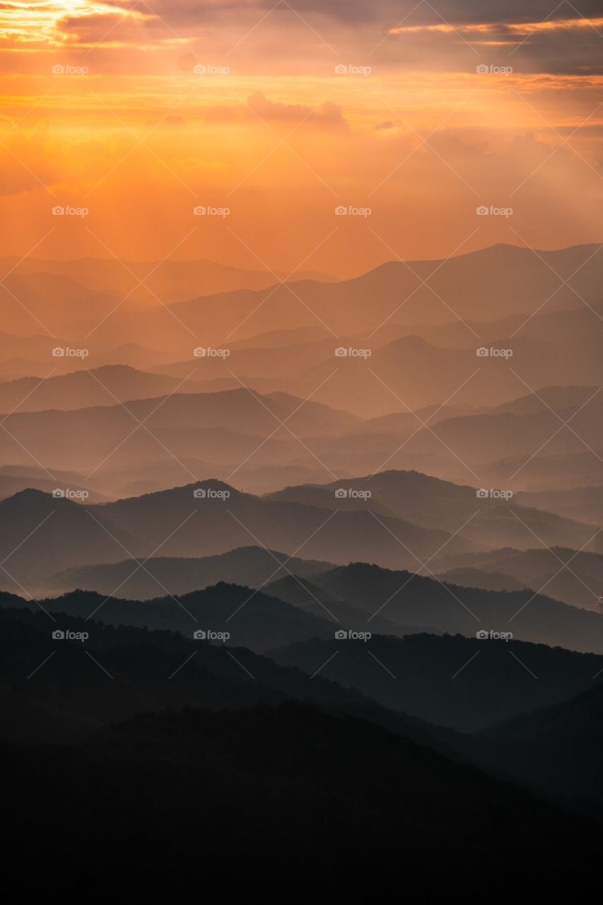 Beautiful composition of the blue ridge mountains In Western North Carolina as the golden light flows across the mountains.