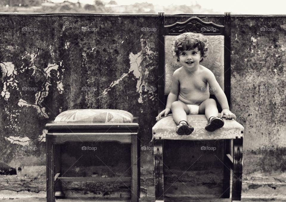 Cute baby sitting on chair