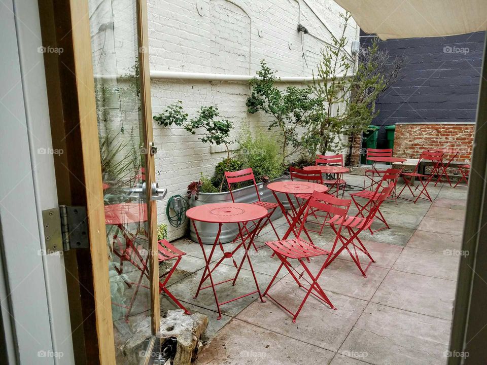 Share this beautiful patio Garden with bright red tables and chairs