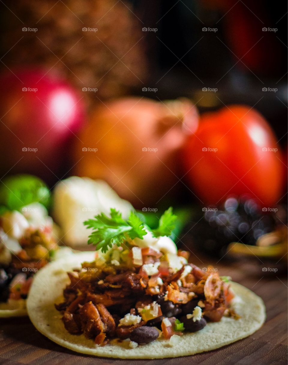 Tacos Frescos. Fresh tacos with fruits and vegetables in the background 
