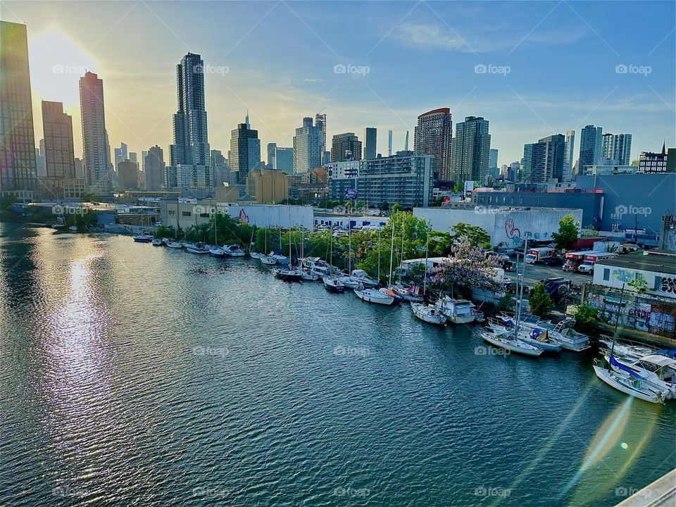 This is “Newtown Creek”, an ocean inlet of the “East River” seen from the “Pulaski Bridge” that connects LIC, Queens to “Greenpoint”, Brooklyn. Across the water in the distance we see the “Manhattan” skyline. 2024. Hypnotic Productions