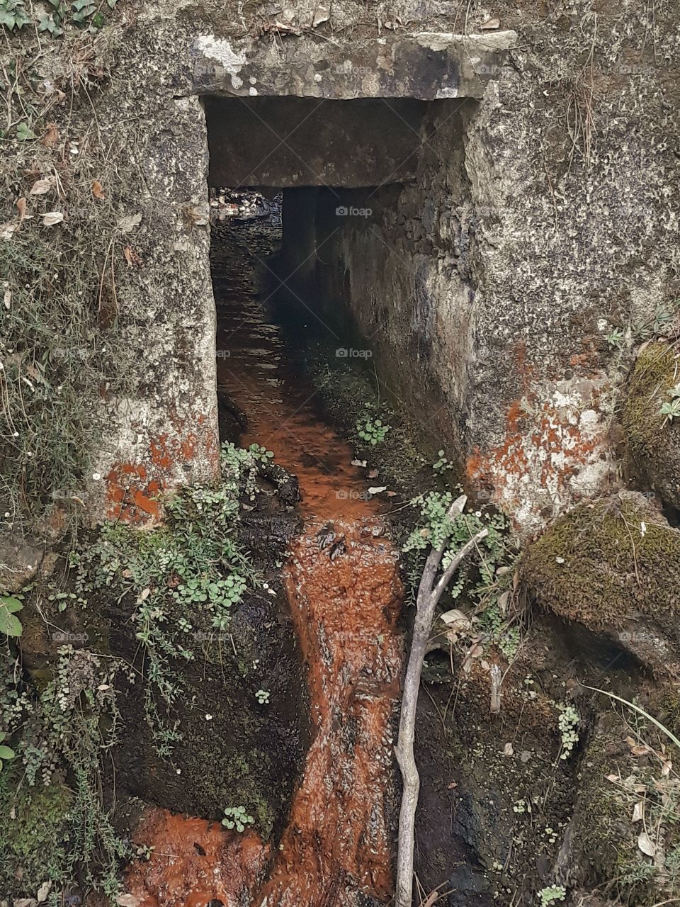 small tunnel river with waterfall in the end