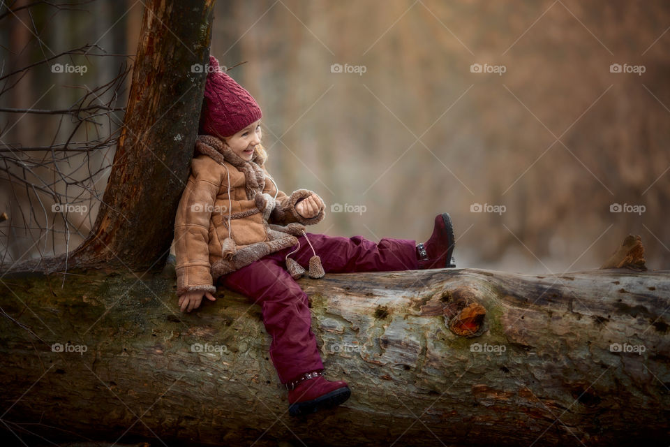 Little girl portrait at early spring forest