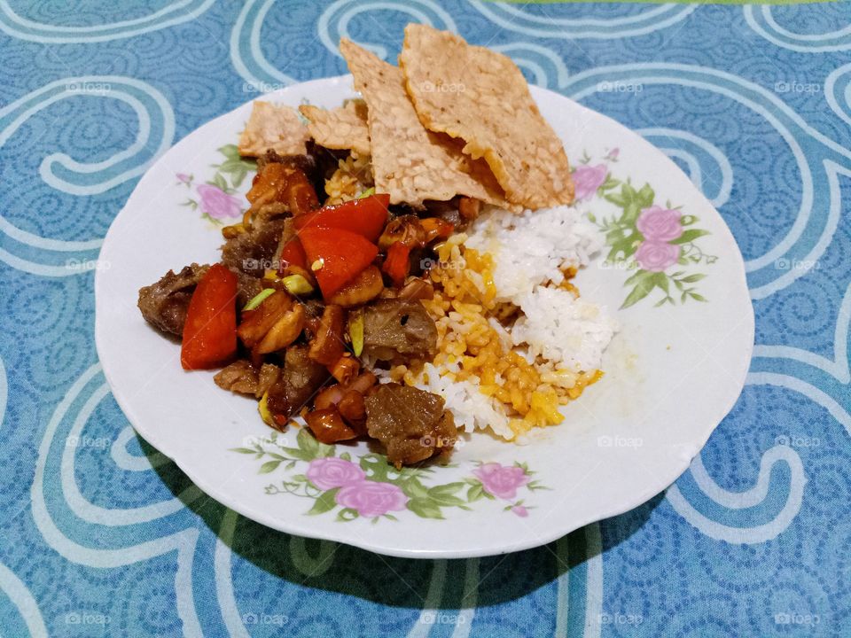 Stir-fry beef with soy sauce with tomato, chili, and shallots