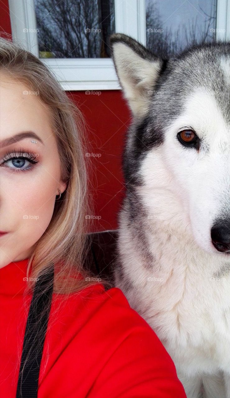Blue-eyed slovak girl with her siberian husky.