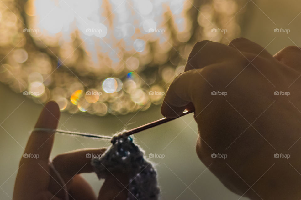 Close-up of a person's hand crocheting