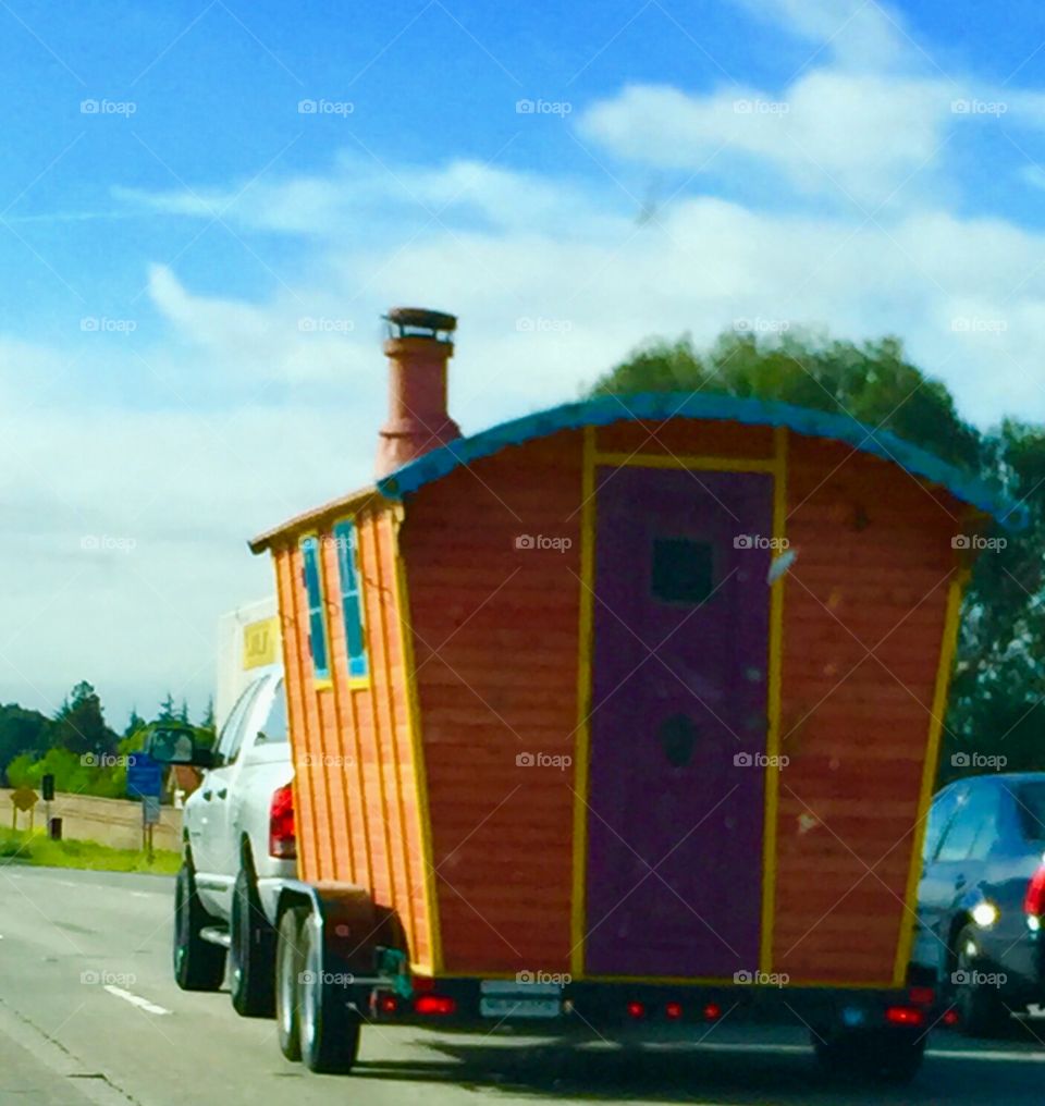 Toilet on wheels. Multicolored restroom being transported or someone really loves their seat.