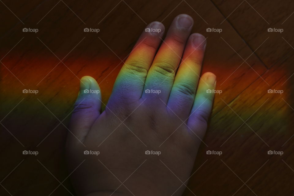 rainbow on a hand of a kid celebrating gay union