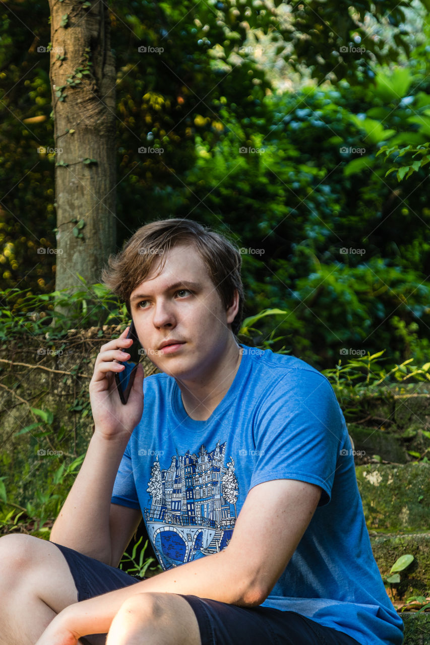 A handsome teenager talking on the mobile phone