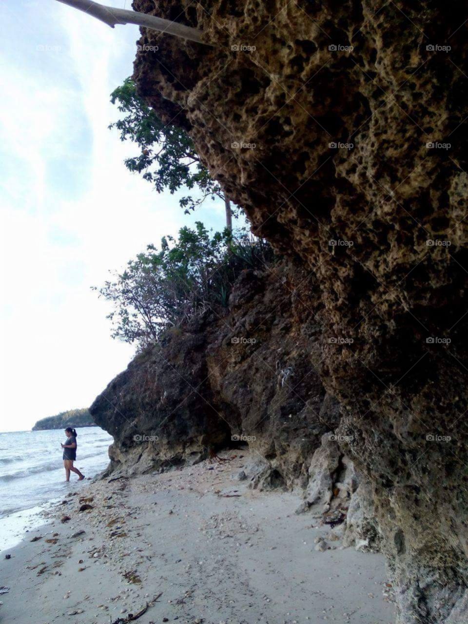 White/yellow sand seaside, tiny rocks and pebbles, shells and more. Sea banks and trees around. Feel the nature, Bogo Maria Siquijor Philippines.