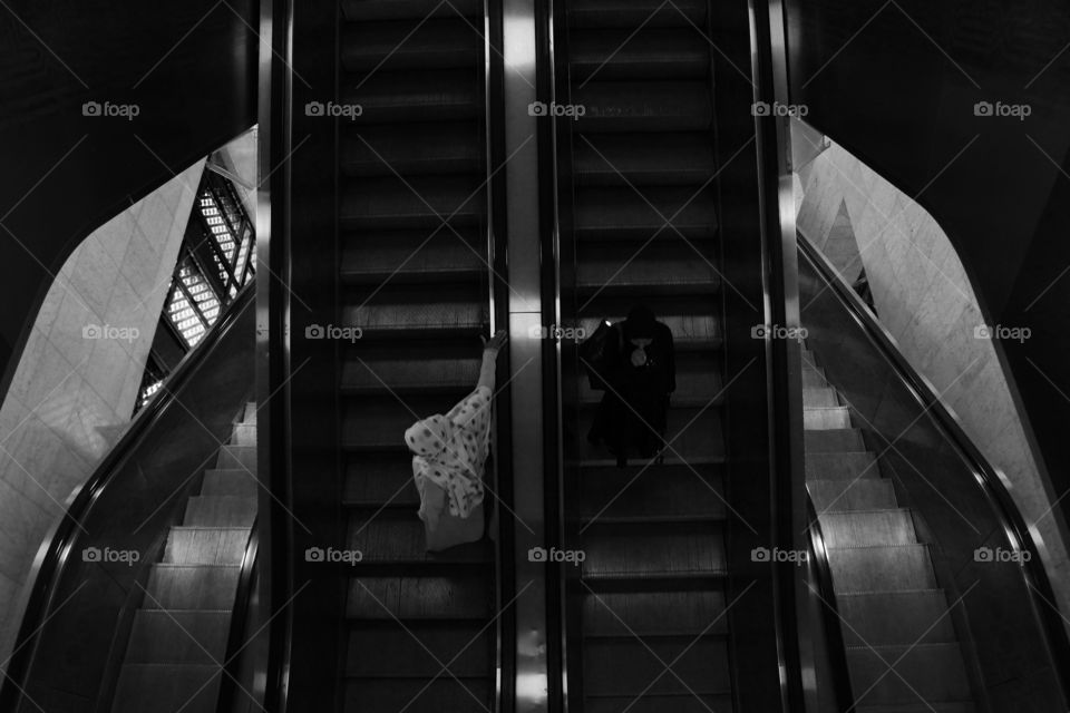 two woman on escalator, haram mosque, mecca