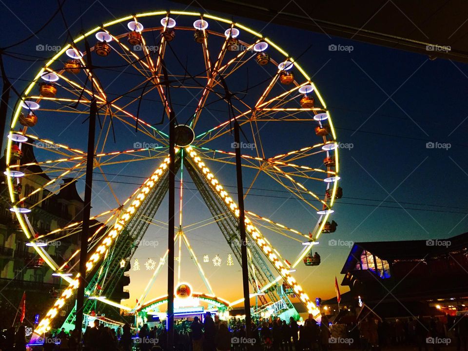 Enlightened night wheel at Montreaux Christmas market in Switzerland 