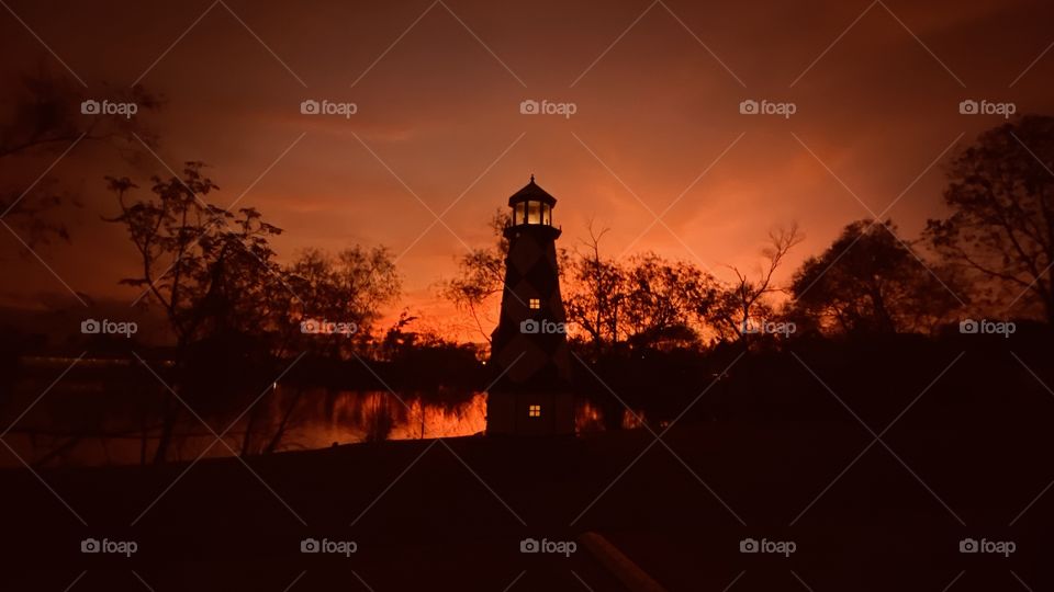 Orange Sky at Night Sailors Delight. Silhouette Reflections of Lake Waters Color of Orange