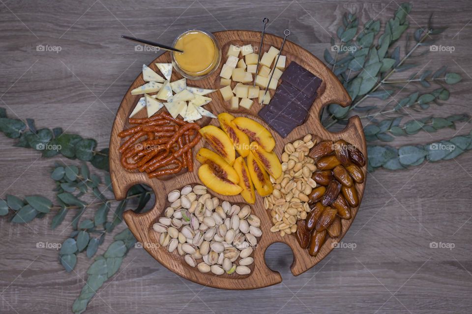 Appetizer on wooden wine table with eucalyptus decor