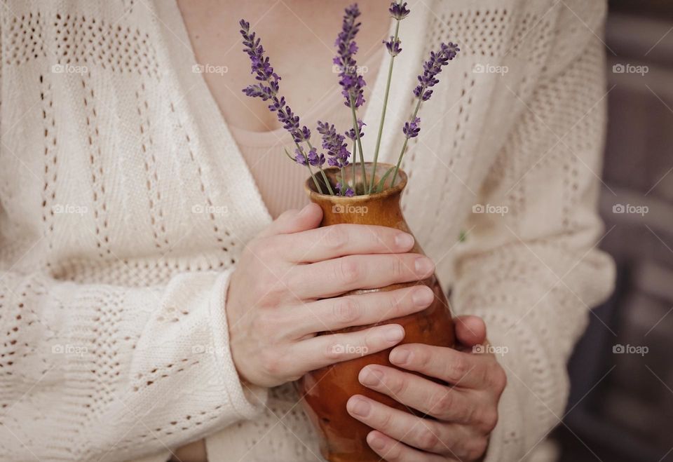 Flowers in a vase in woman’s hands