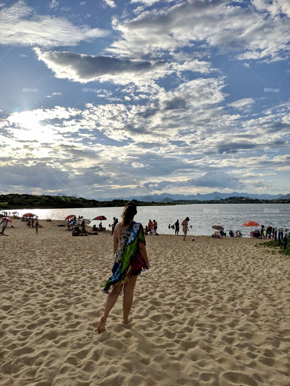 A woman happy to be able to go to the beach during a sunny day