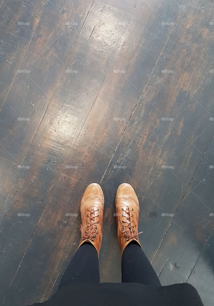 leather boots on rustic floor