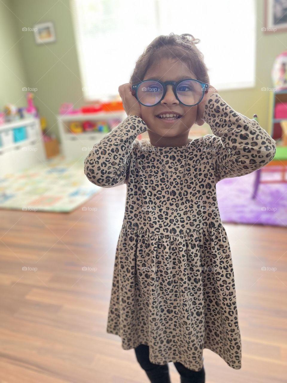 Little girl tries on Mommy’s reading glasses, mommy needs glasses to read, little girl pokes fun of mommy needing glasses, middle age adult problems 