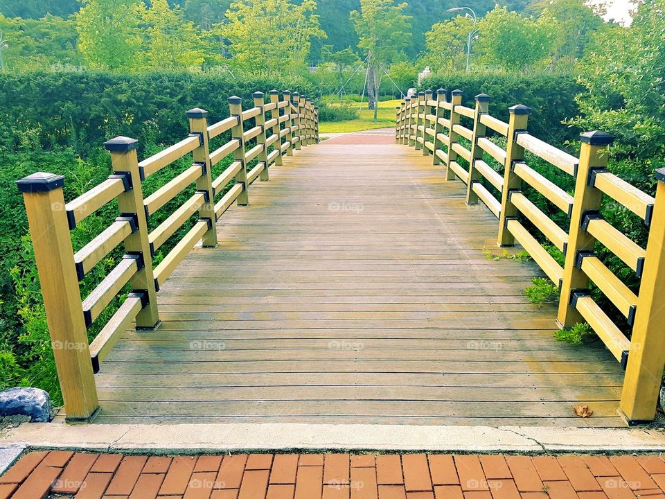 The bridge in the country side on summer time.
everywhere is green, fresh air, and so relaxing.
thanks to the bright sunlight too , it makes this bridge more fascinating.