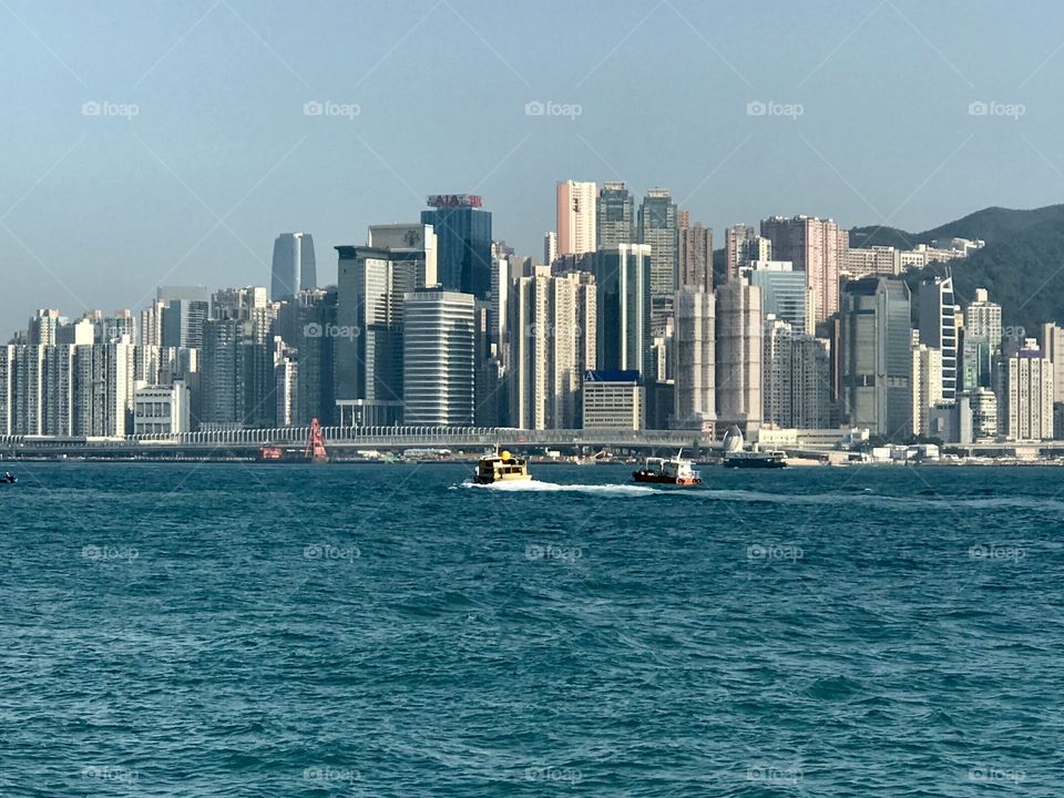 Boats in the harbor around the city of Hong Kong 