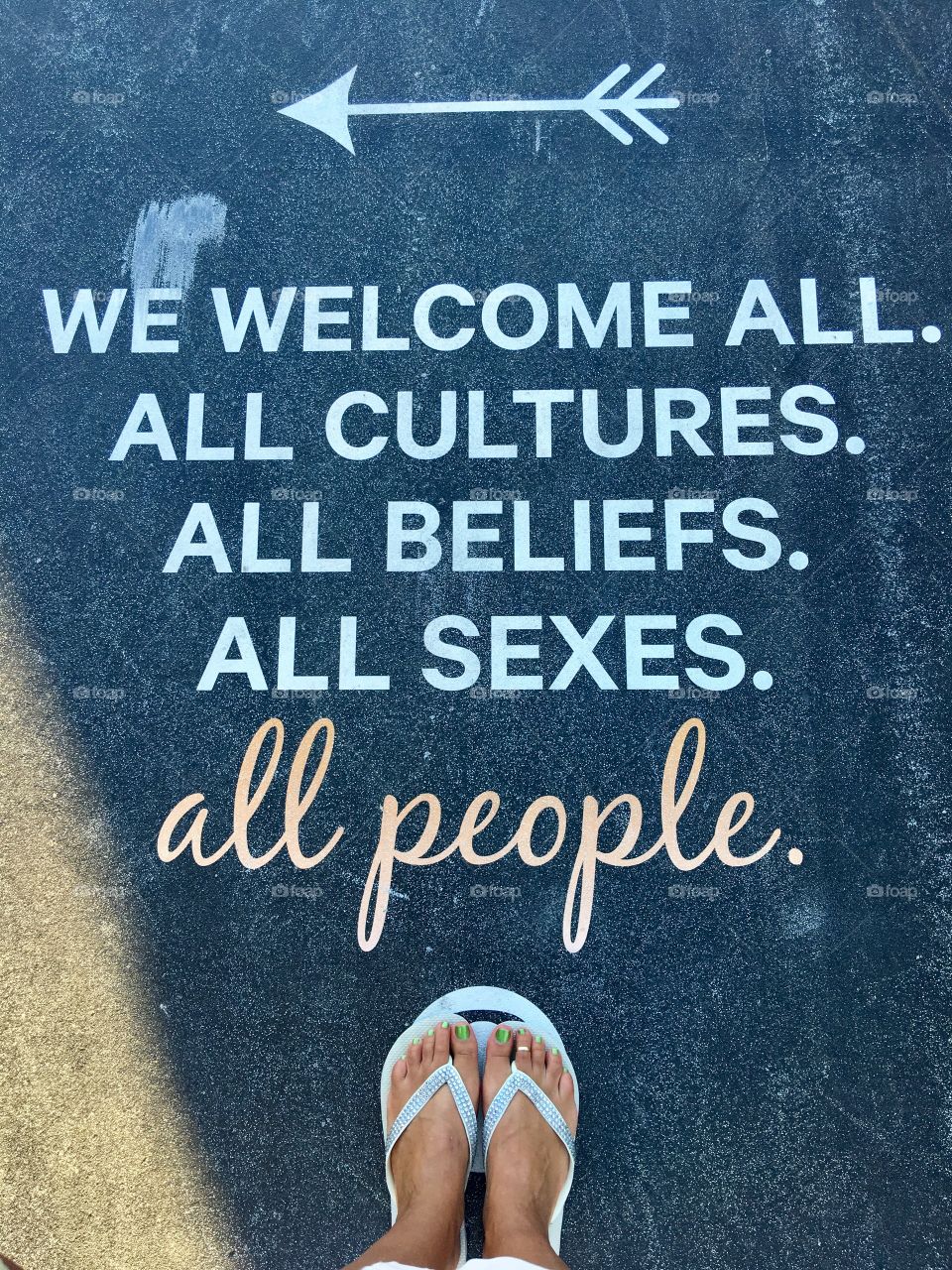 Inspirational sidewalk sign, Welcome all people, from where I stand.