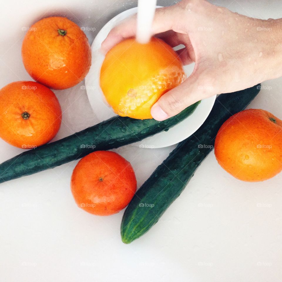 Washing oranges and cucumbers