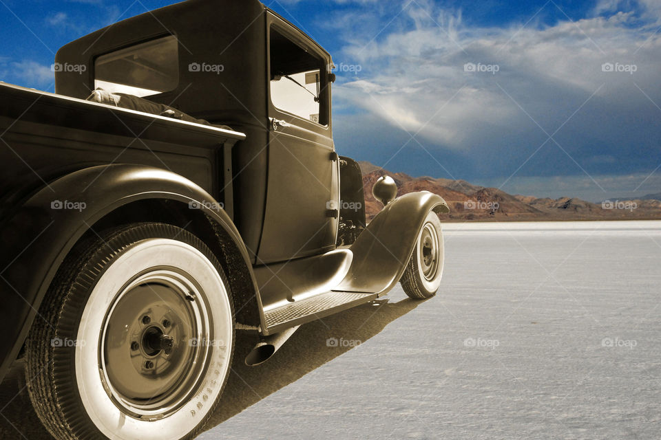 Classic Ford facing the mountains on the Bonneville Salt Flats in Utah