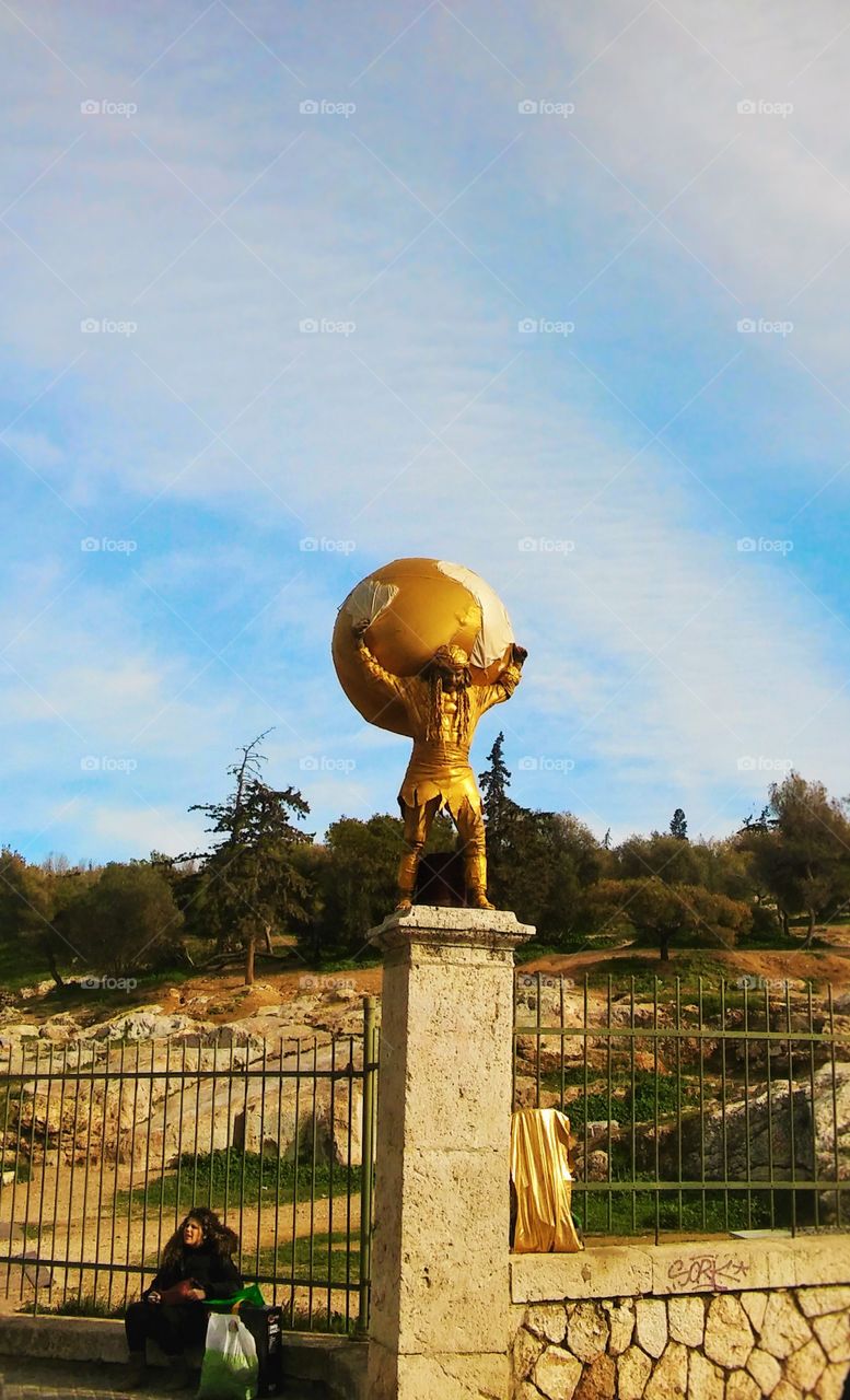 Golden statue against blue sky