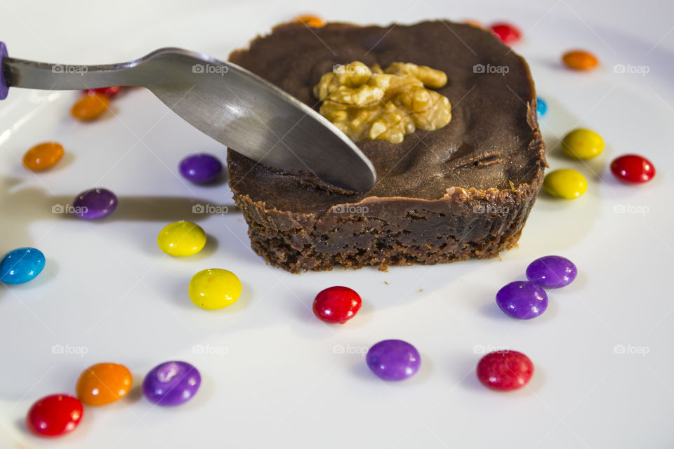 Delicious chocolate brownie and colorful candies