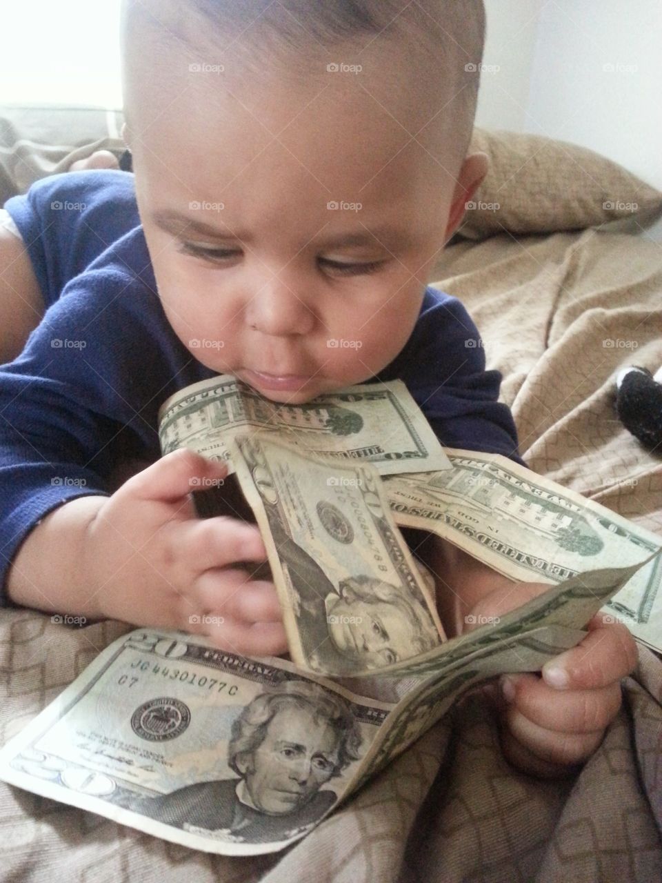 Boy holding dollar notes