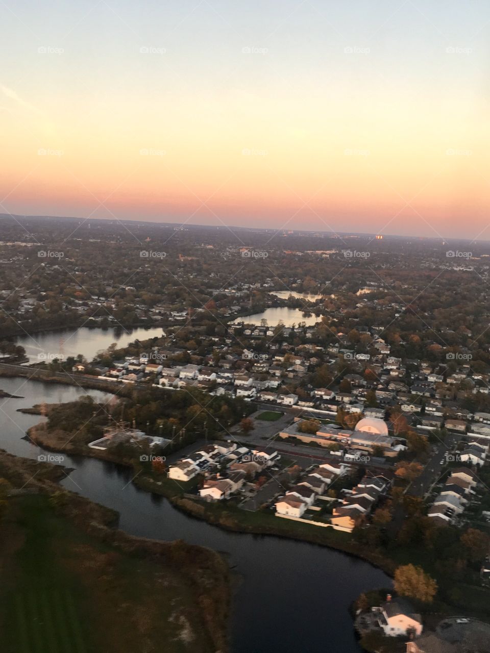 A view of a suburban town at sunset from an airplane 
