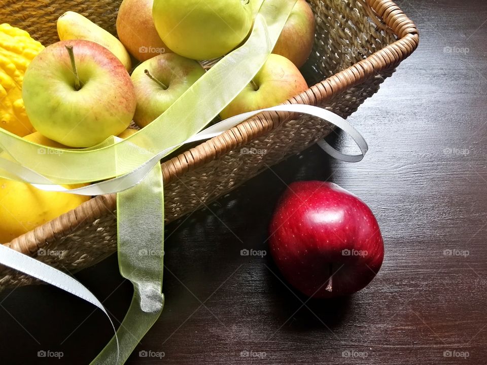 Close-up of apples in basket with ribbon
